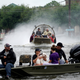 People and a pet are rescued from flood waters from Hurricane Harvey on an air boat in Dickinson, Texas Aug 27.